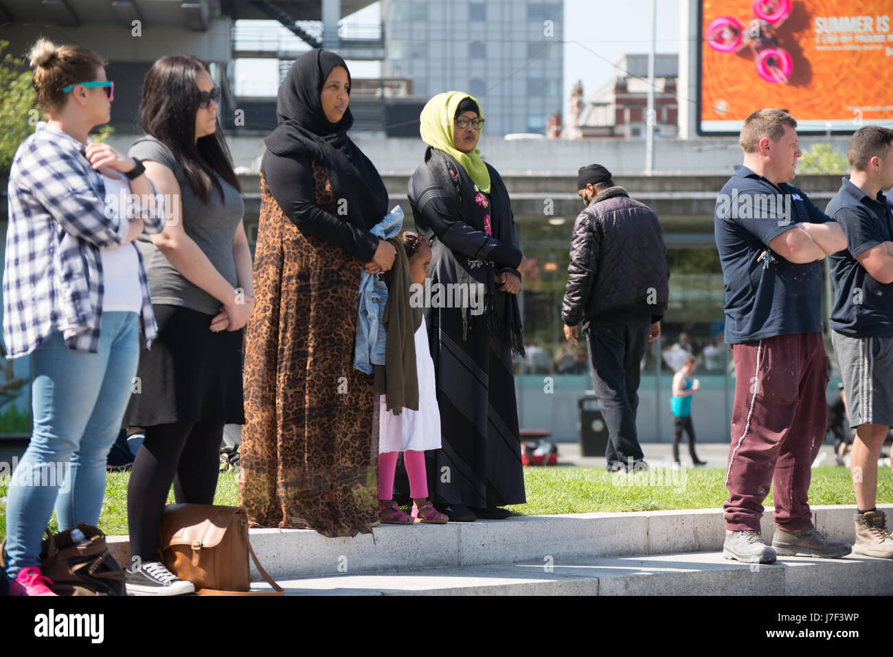 Manchester, UK. 25th May, 2017. People participate in a minute silence, to remember the victims of the bombing of the Manchester Arena, in central Manchester, United Kingdom on Thursday, May 25th, 2017. Greater Manchester Police are treating the explosion after the Ariana Grande concert, which took place on 05/22/2017 at Manchester Arena, as a terrorist incident. Credit: Jonathan Nicholson/Alamy Live News Stock Photo