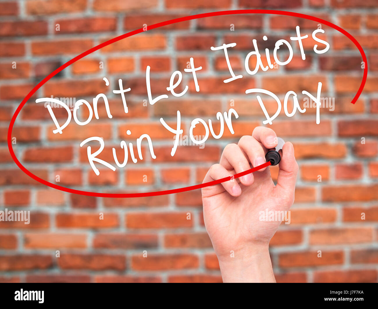 Man Hand writing Don't Let Idiots Ruin Your Day with black marker on ...