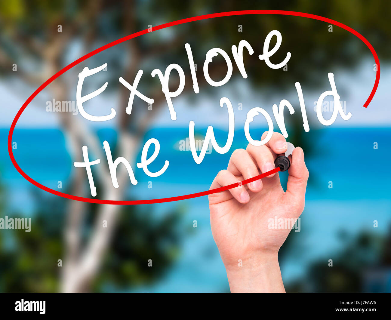 Man Hand writing Explore the World with black marker on visual screen ...