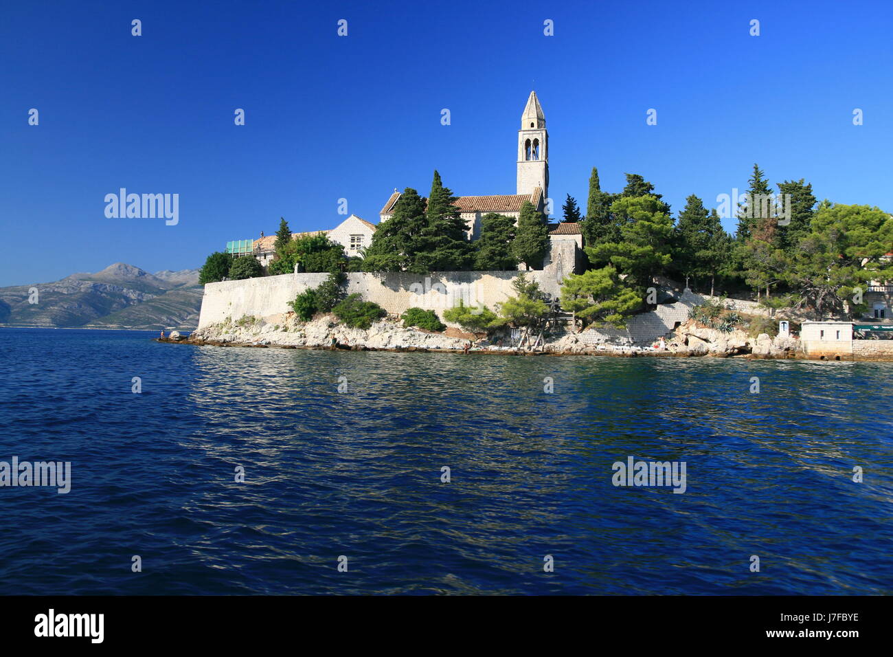 croatia salt water sea ocean water dalmatia blue church tree trees holiday Stock Photo