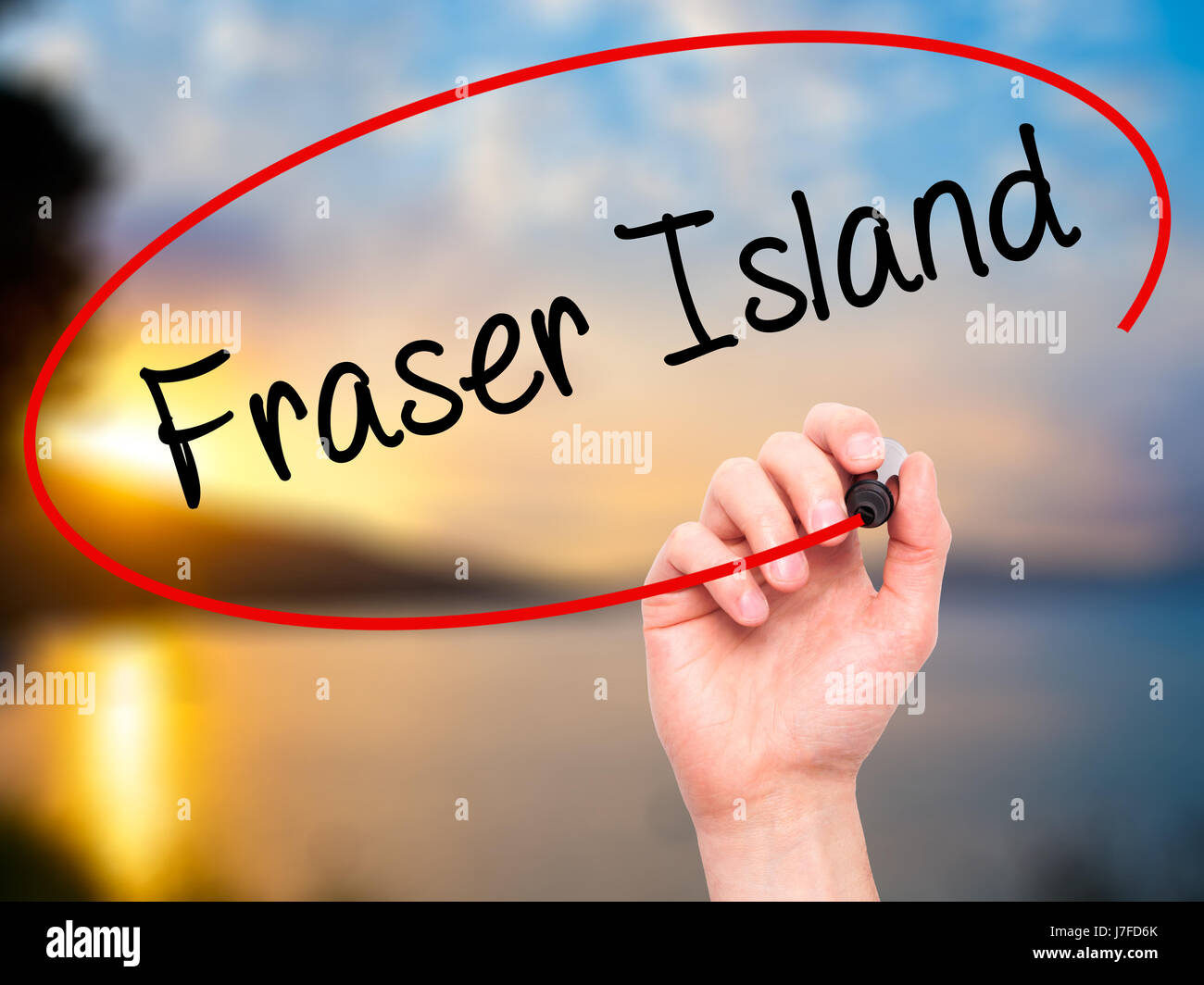 Man Hand writing Fraser Island with black marker on visual screen. Isolated on background. Business, technology, internet concept. Stock  Photo Stock Photo