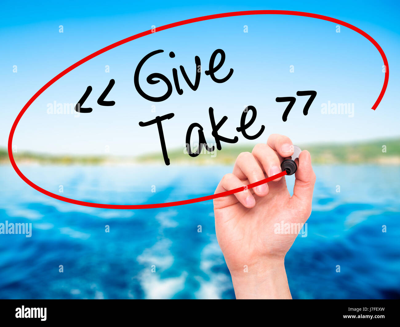 Man Hand writing Give - Take with black marker on visual screen ...