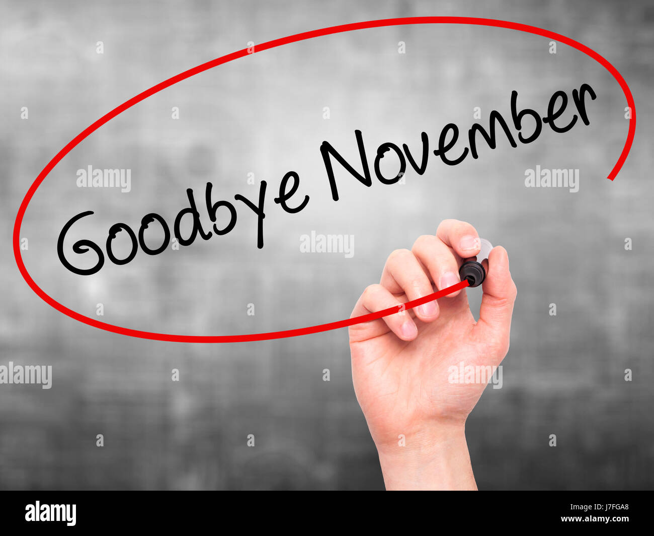Finalizing November Man Hand writing Goodbye November with black marker on visual screen ...