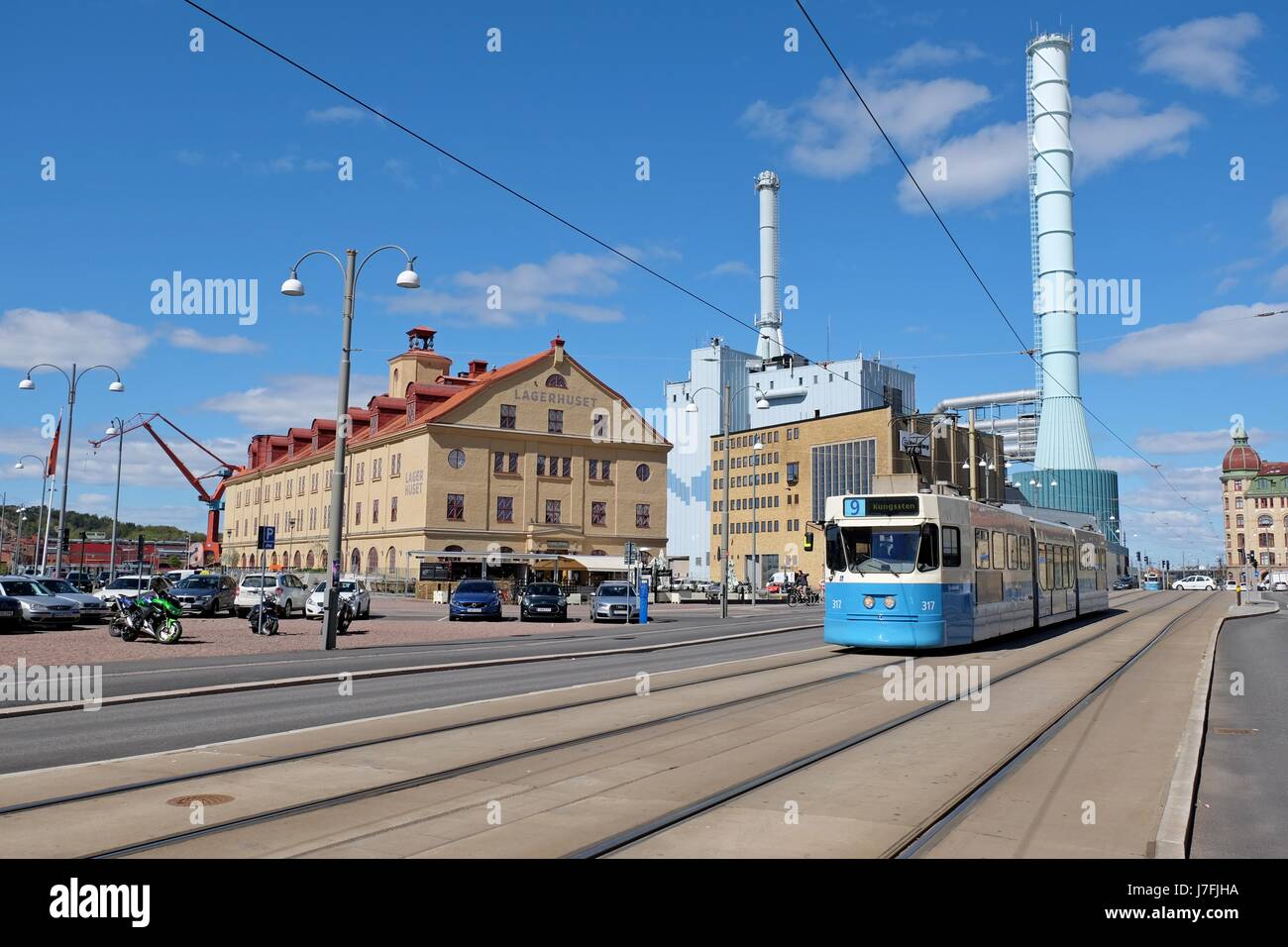 Gothenburg, Sweden - May, 2017: Tram on a street and tubes of Goteborg Energi building (generating energy from waste material)  of Gothenburg, Sweden. Stock Photo