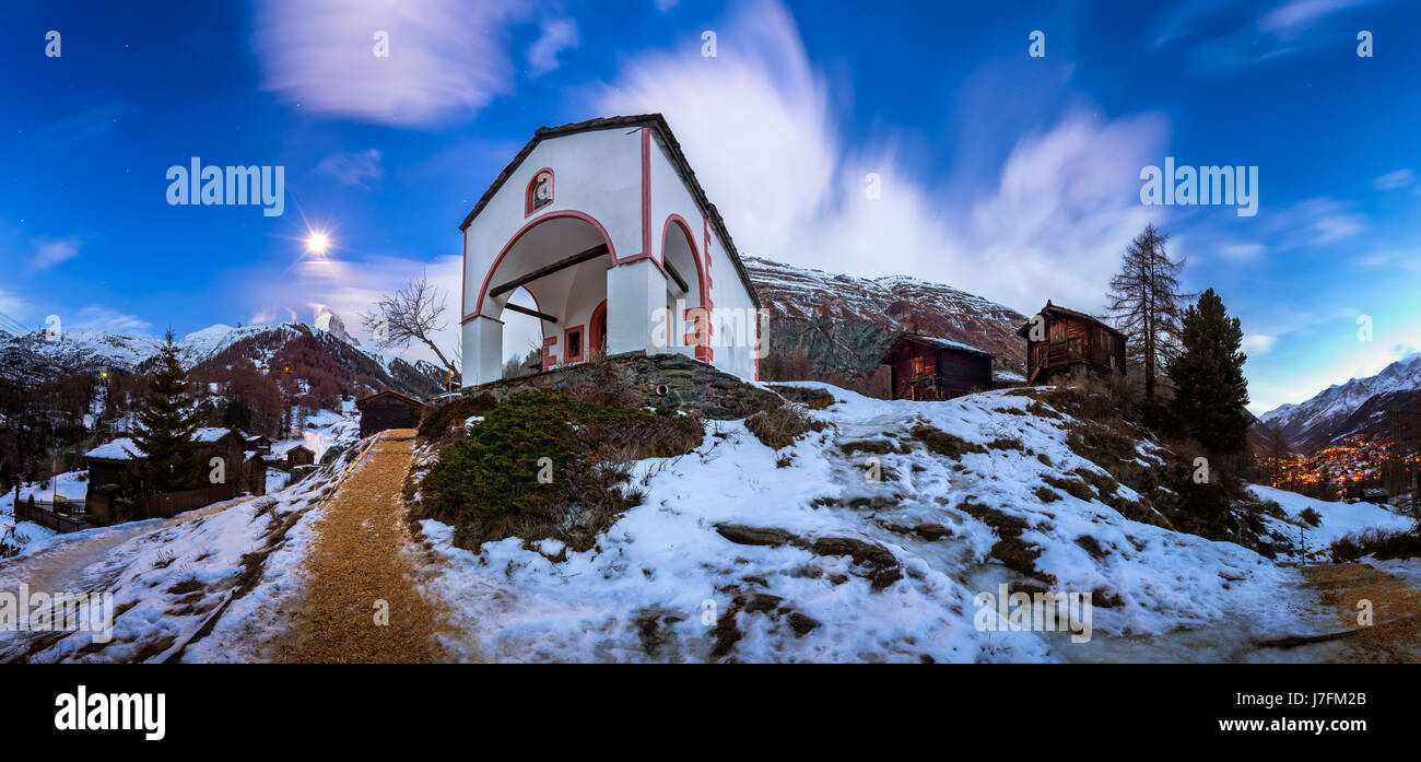 White Church on the Hill and Matterhorn Peak before Dawn, Zermatt, Switzerland Stock Photo