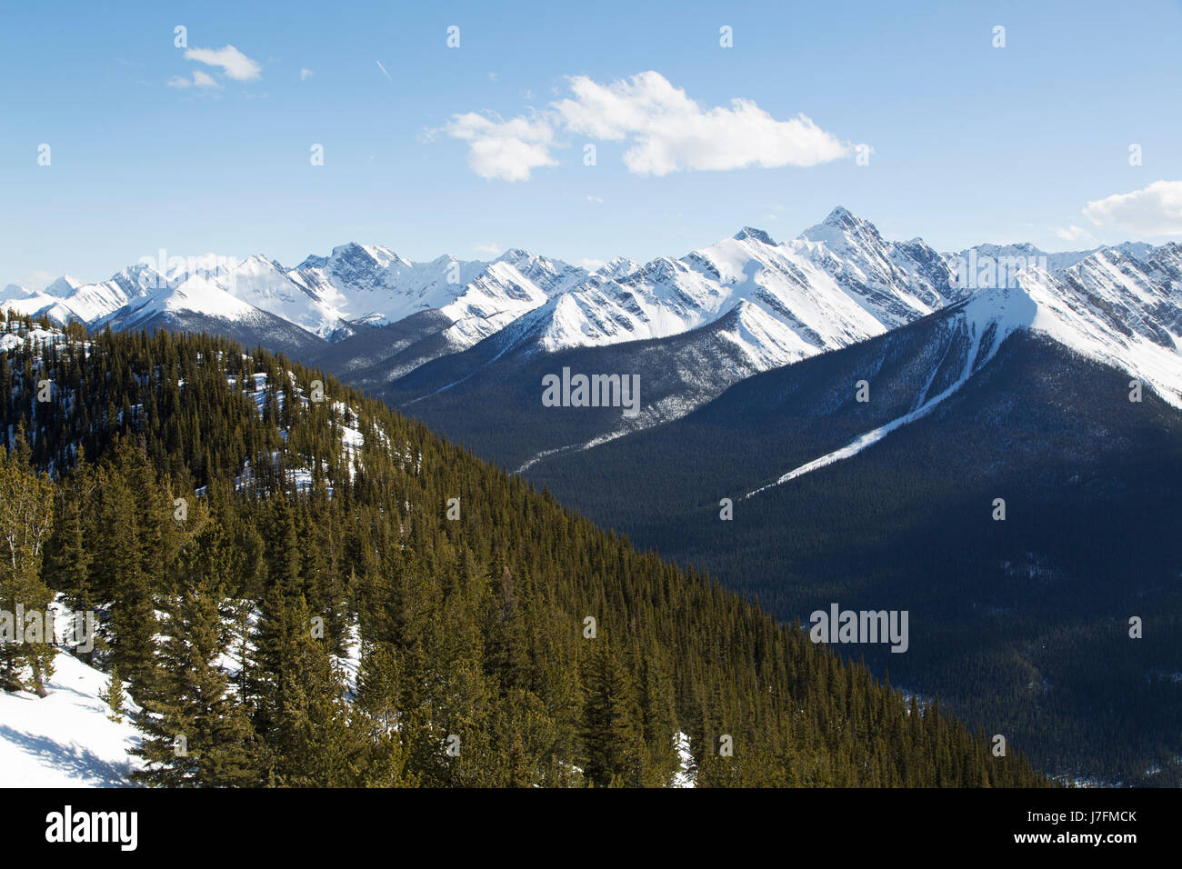 Woodland and snow-capped mountains at Banff National Park in Banff, Alberta, Canada. The national park was established as Canada's first, in 1885. Stock Photo