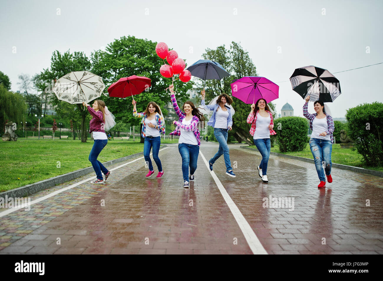 Group Of Six Girls Run Jump And Fun At Hen Party With Umbrella Under Rain And Balloons Stock Photo Alamy Group Of Six Girls Run Jump And Fun At Hen Party With Umbrella Under Rain And Balloons Stock Photo Alamy