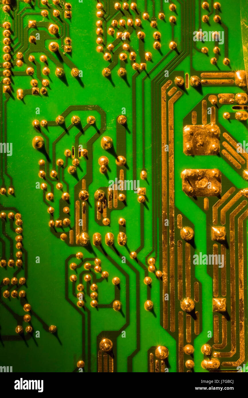 Green and gold computer circuit board close-up, Studio Composition Stock Photo