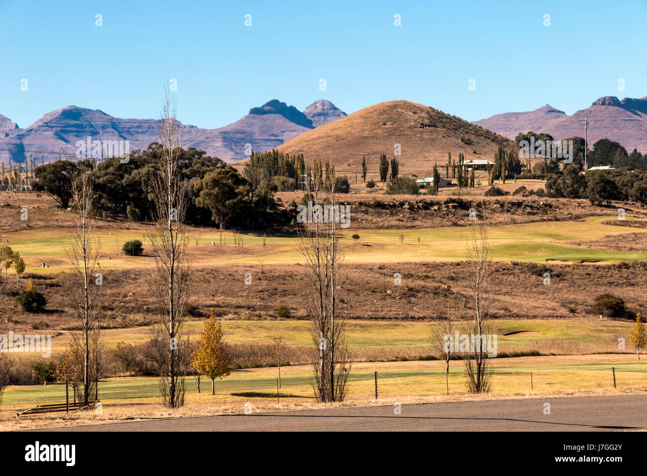 View of mountain countryside and golf course at entrance to the town of Clarens, Orange Free State in South Africa Stock Photo