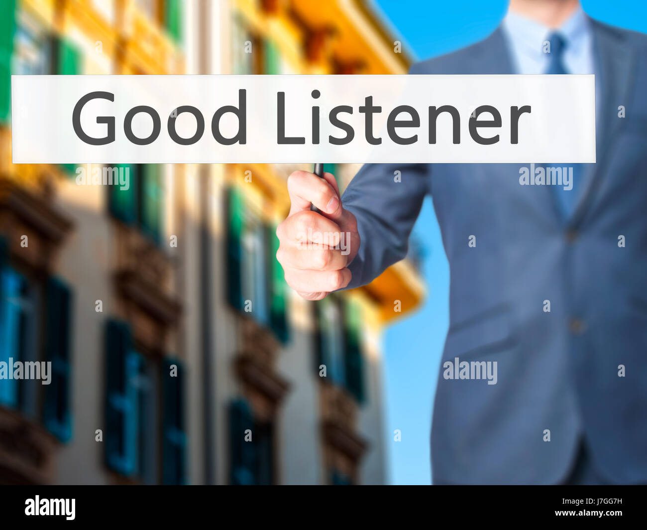 Good Listener - Businessman hand holding sign. Business, technology, internet concept. Stock Photo Stock Photo