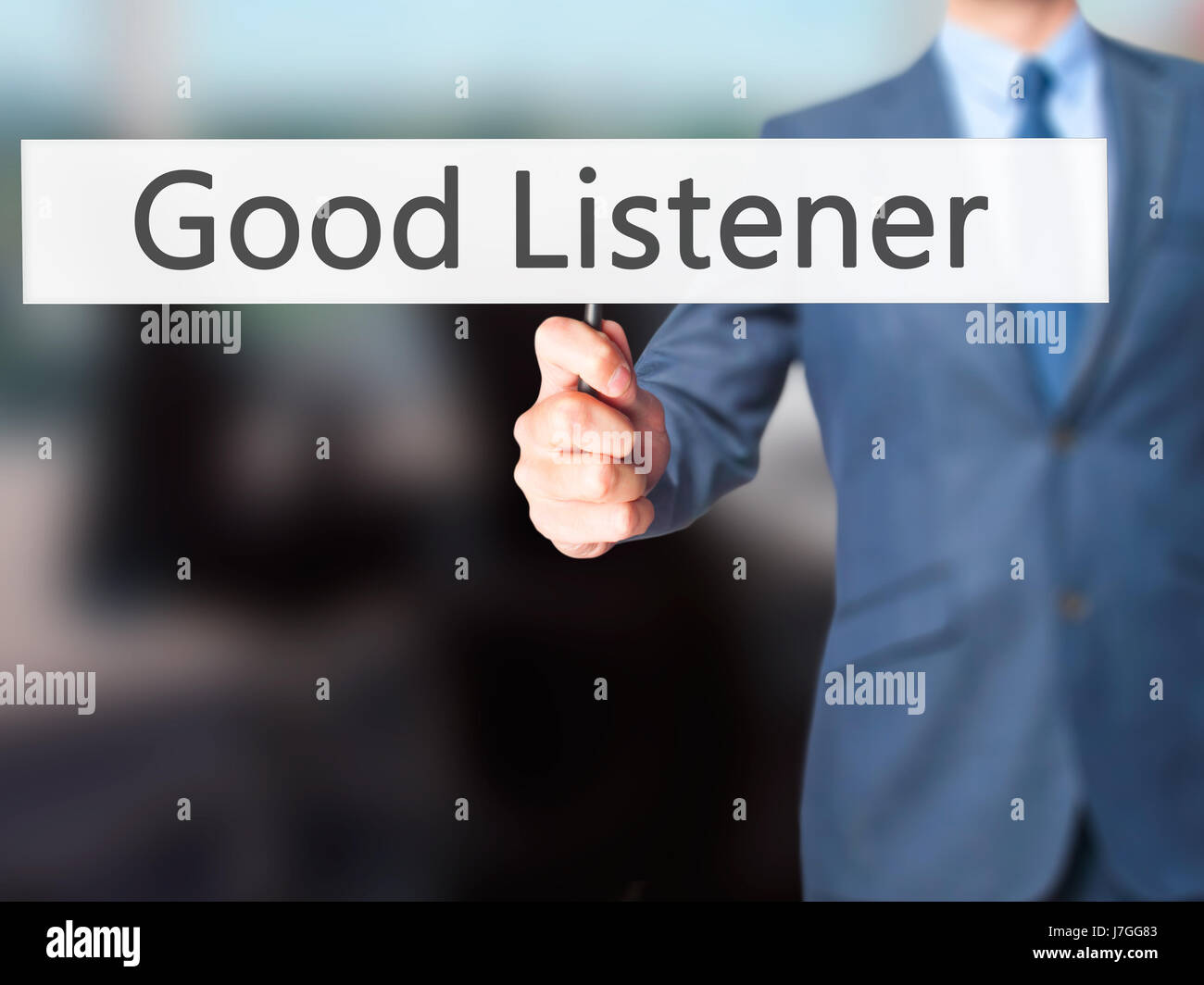 Good Listener - Businessman hand holding sign. Business, technology, internet concept. Stock Photo Stock Photo