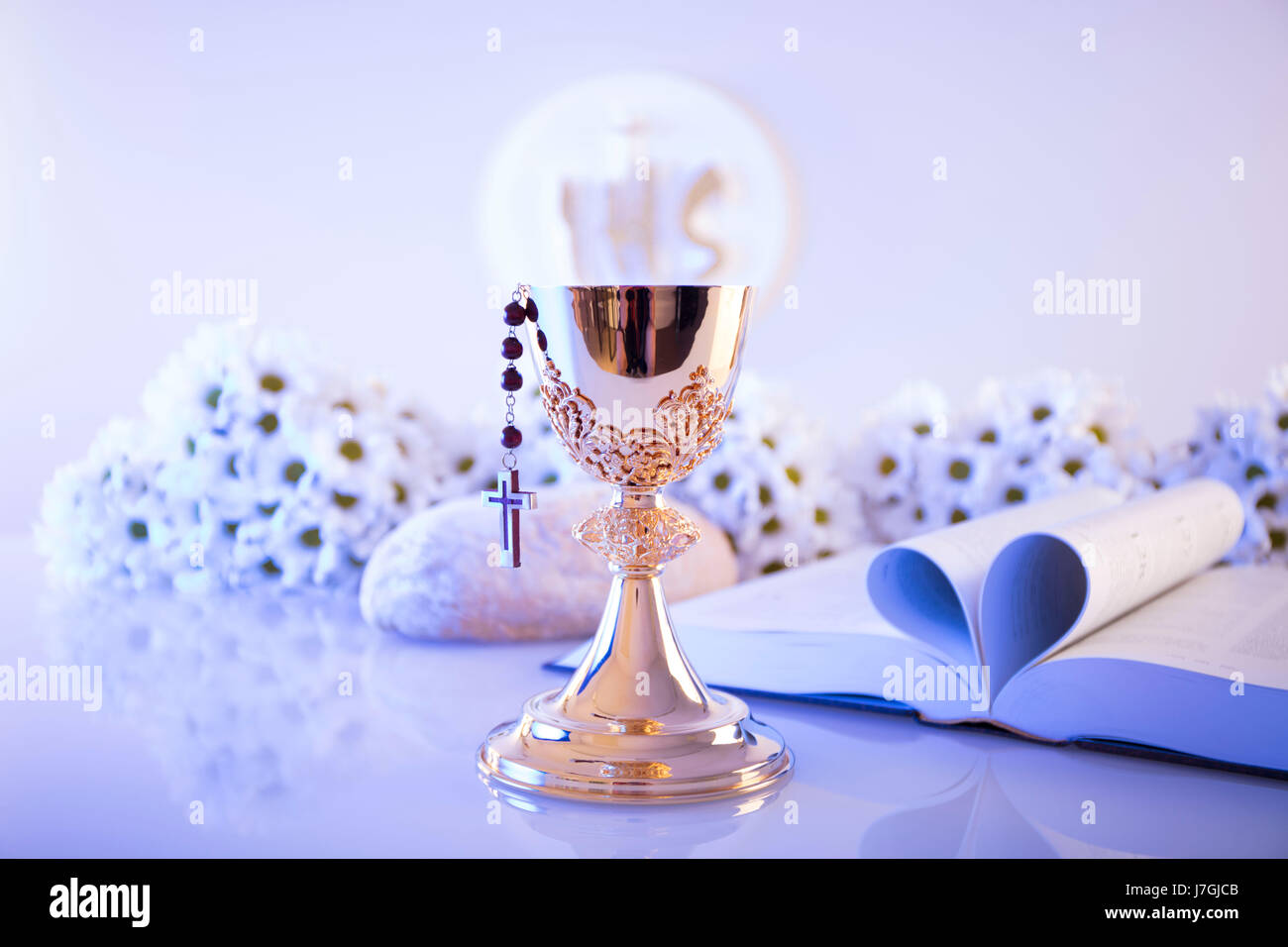 First Holy Communion. Catholic religion theme. Crucifix, Bible, bread