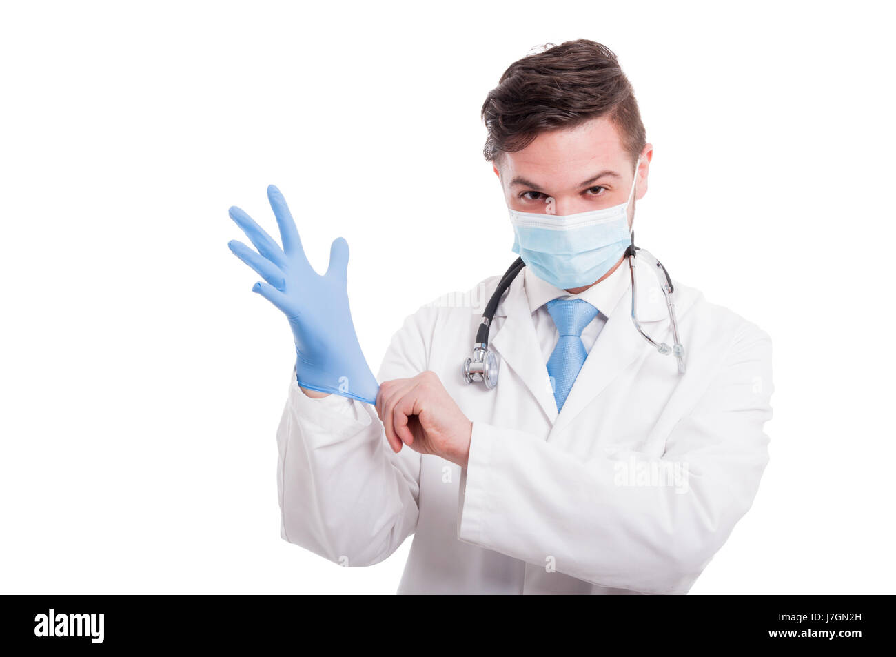 Young medic pulling on medical gloves getting ready for operation