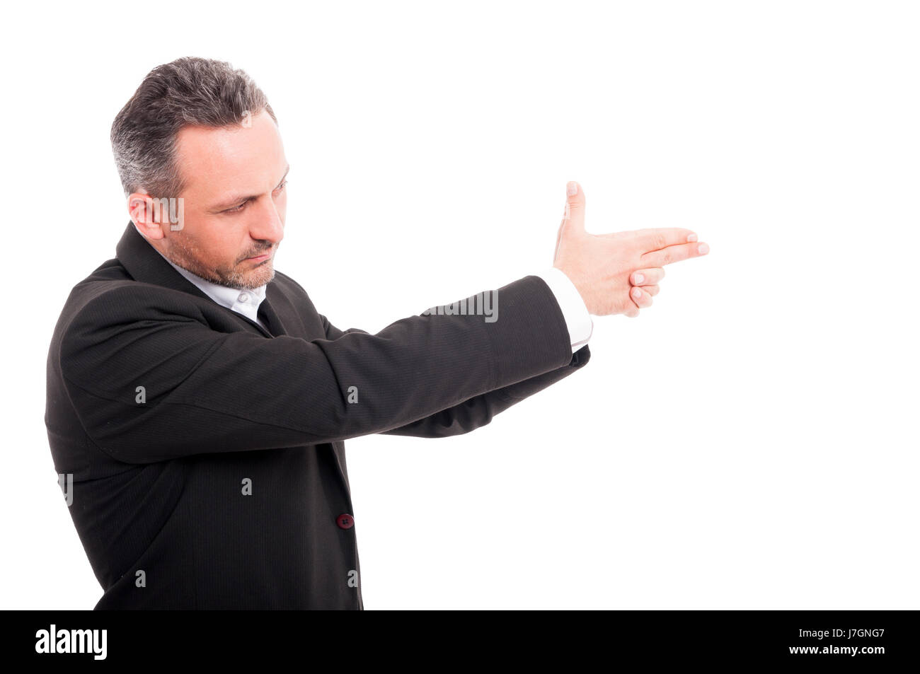 Secret agent taking aim with his hand and doing a gun gesture isolated on white Stock Photo