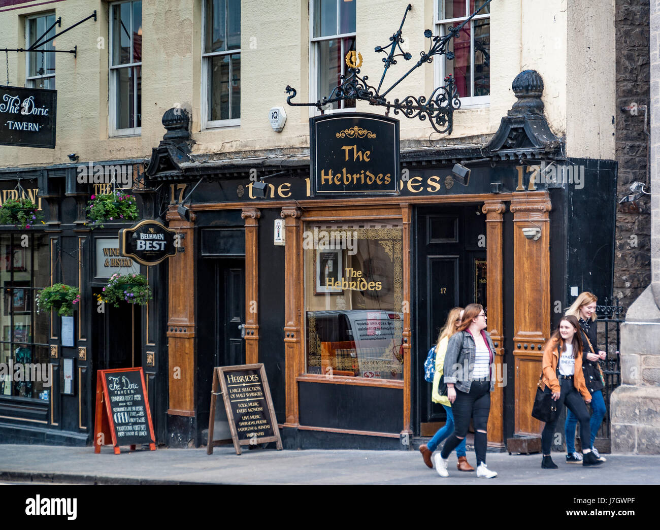 Tourists passing a pub on Market street in Edinburgh Scotland Stock Photo