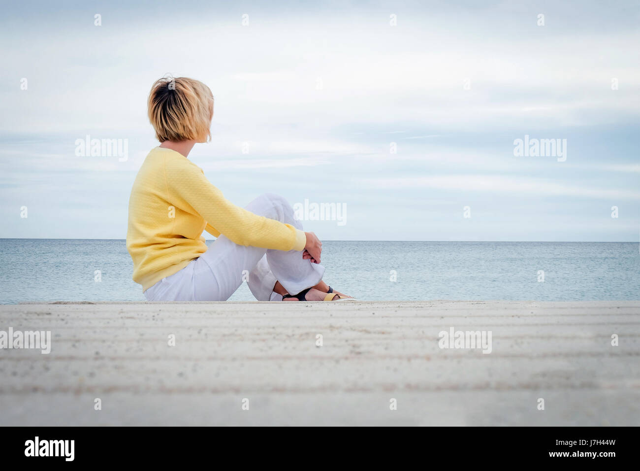 Young blonde woman looking through the sea Stock Photo - Alamy