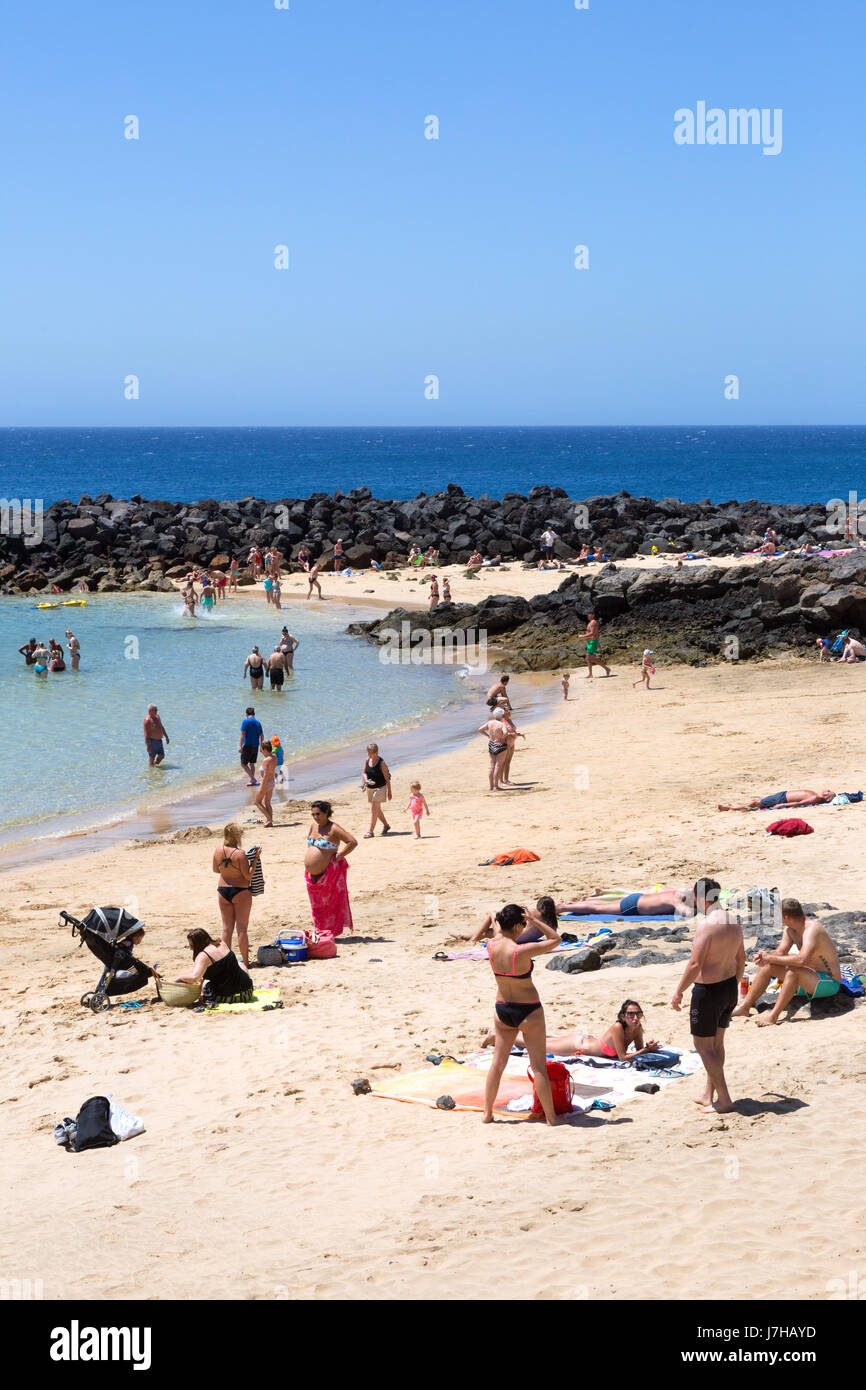 Lanzarote, Costa Teguise beach, People on holiday, Playa Bastian, Costa Teguise, Lanzarote, Canary Islands Europe Stock Photo