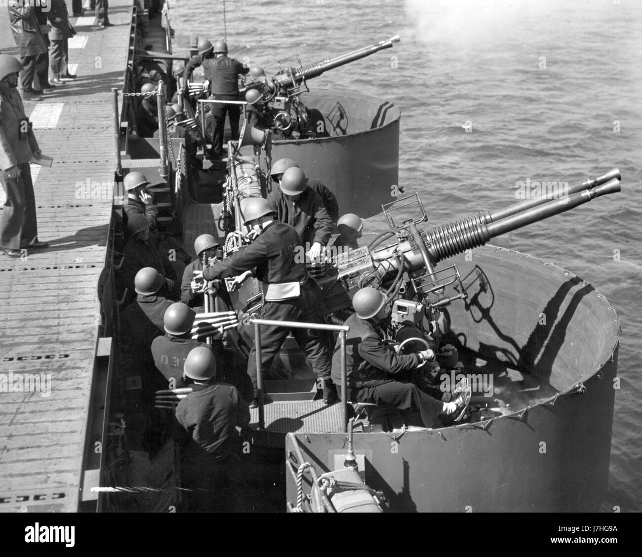 WW II - Two twin 40mm Bofors guns, practicing for battle. Per text printed on this photo's back, these guns are mounted on 'one of America's newest aircraft carriers--a sleek, streamlined warship converted from a light cruiser.''   This Jun. 21, 1943 photo shows Bofors anti-aircraft guns practicing during the ship's shakedown cruise. This Official U.S. Navy photograph does not identify the ship or any of the crew.  To see my related vintage images, Search:  Prestor  vintage   WW II  weapon   vehicle Stock Photo