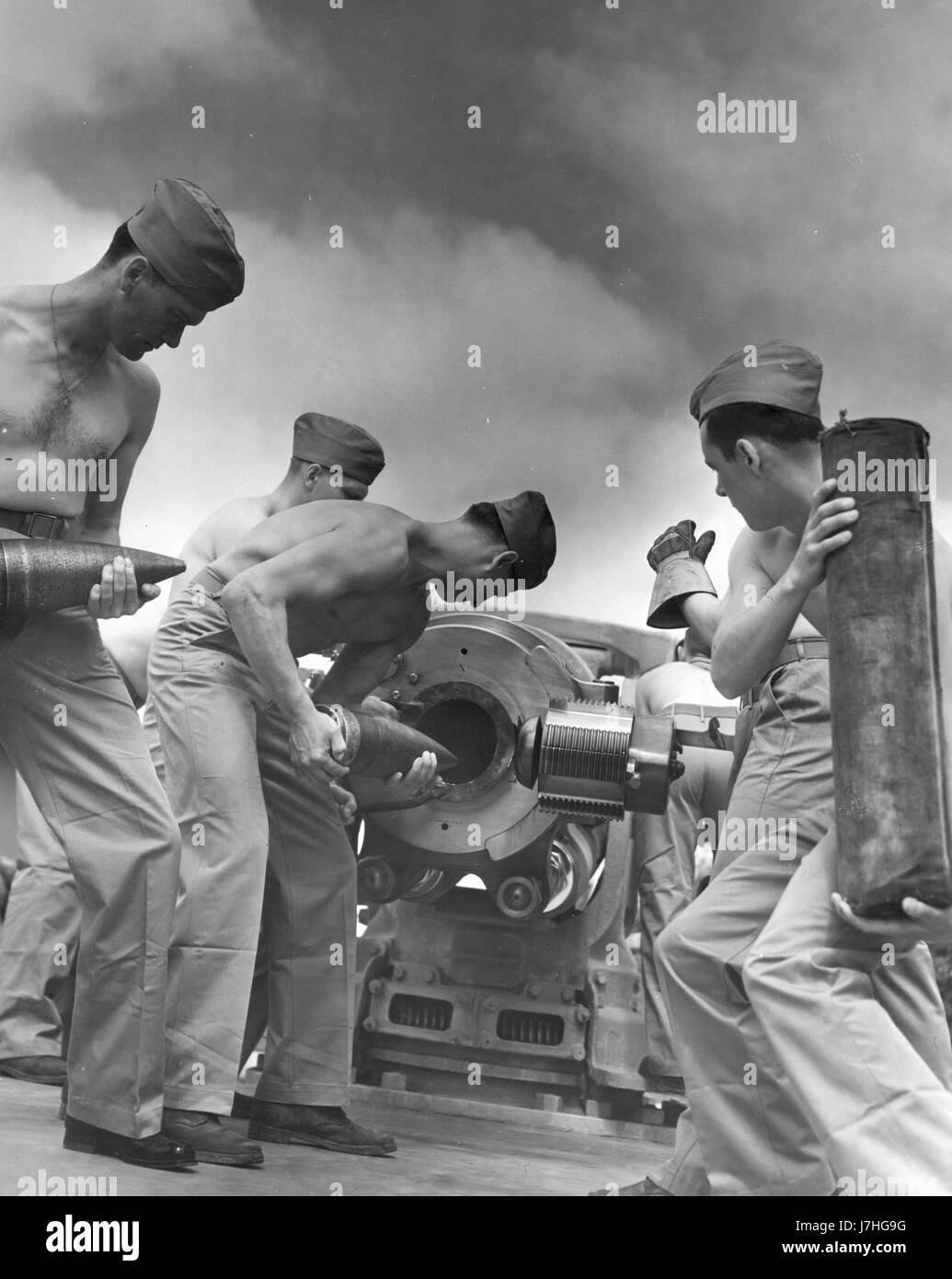 WW II - 'Ready One' - US Marines in Sea School practice loading and firing a 5-inch gun on a ship.  A 5-inch gun is a mounted weapon that has a 5' bore, which is the inside diameter of the barrel.   To see my related vintage images, Search:  Prestor  vintage  weapon  WW II Stock Photo
