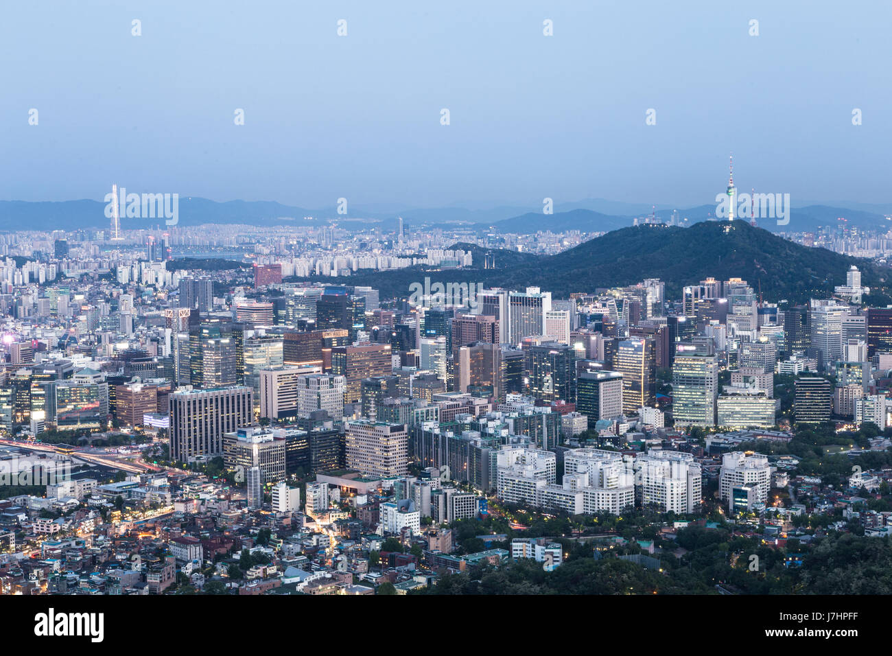 Night falls above the Seoul financial district with Namsan mountain and Seoul Tower in the background in South Korea capital city. Shot from the top o Stock Photo