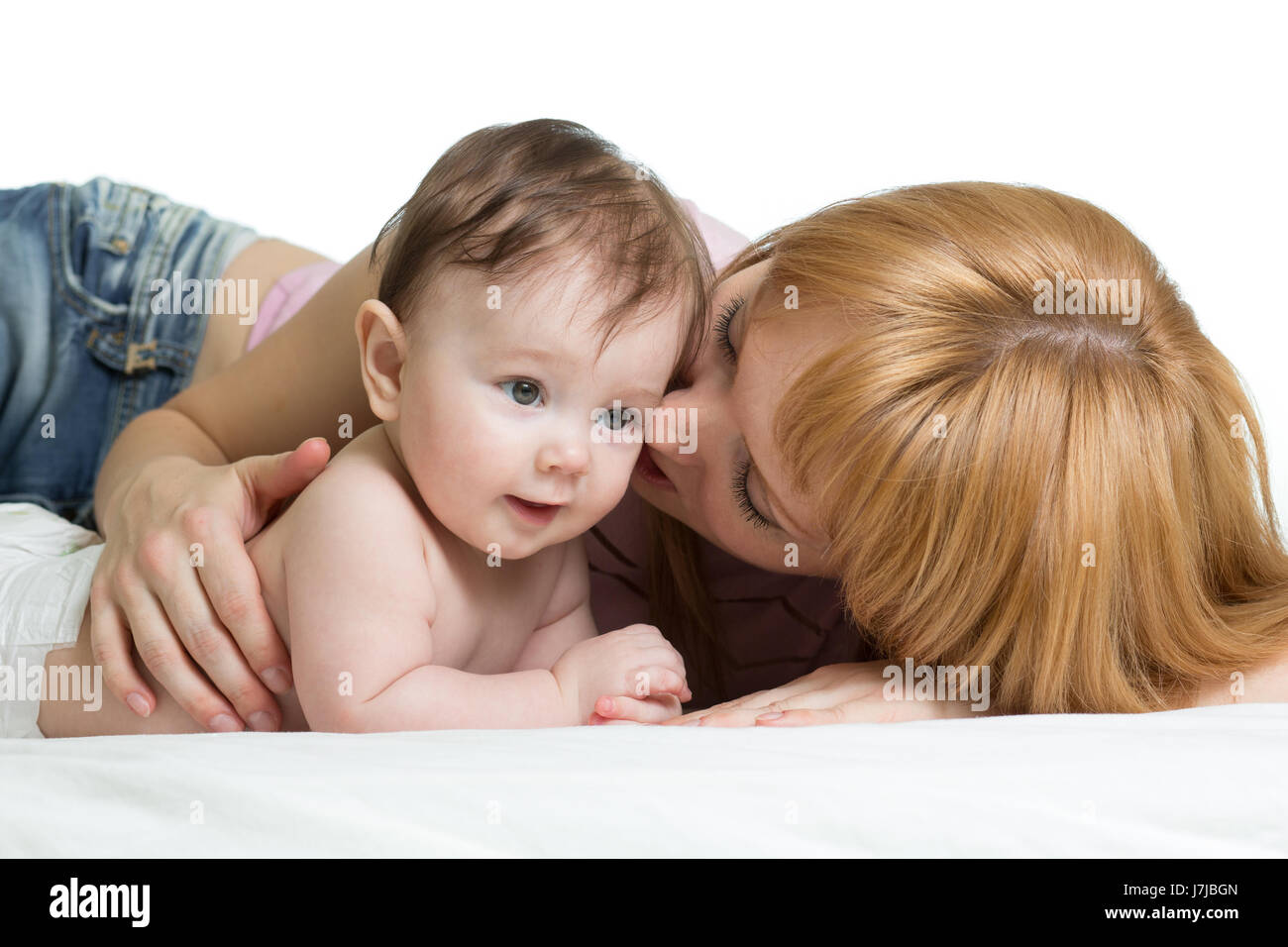 Cute mother kissing her little baby Stock Photo