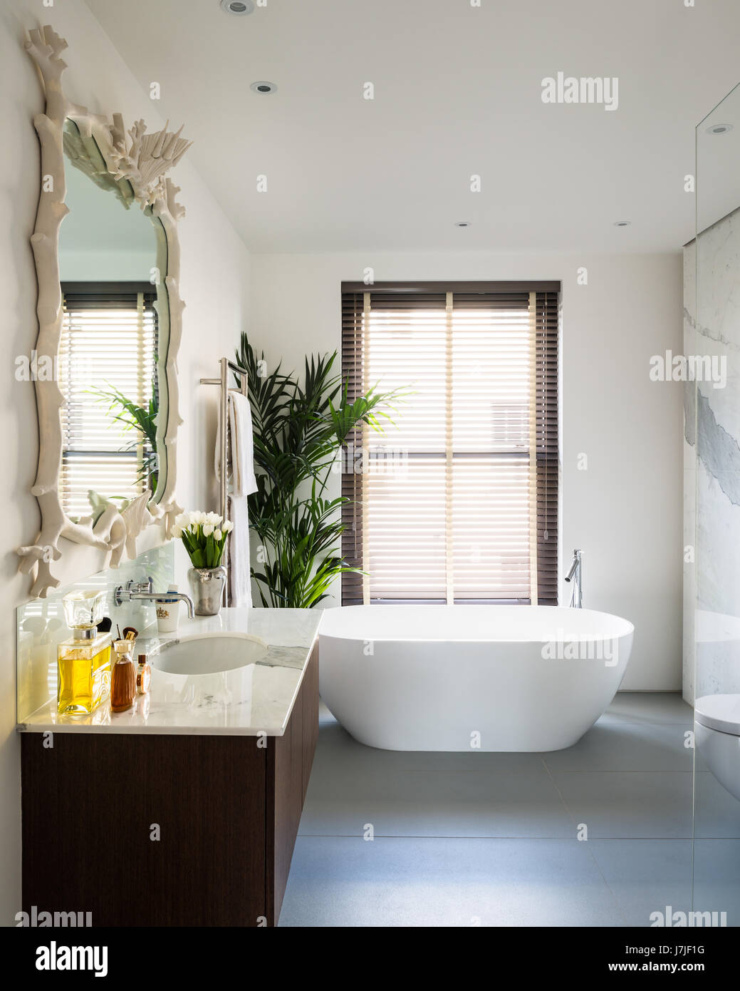 Rococo style mirror by Oriel Harwood in bathroom with bath and sanitary