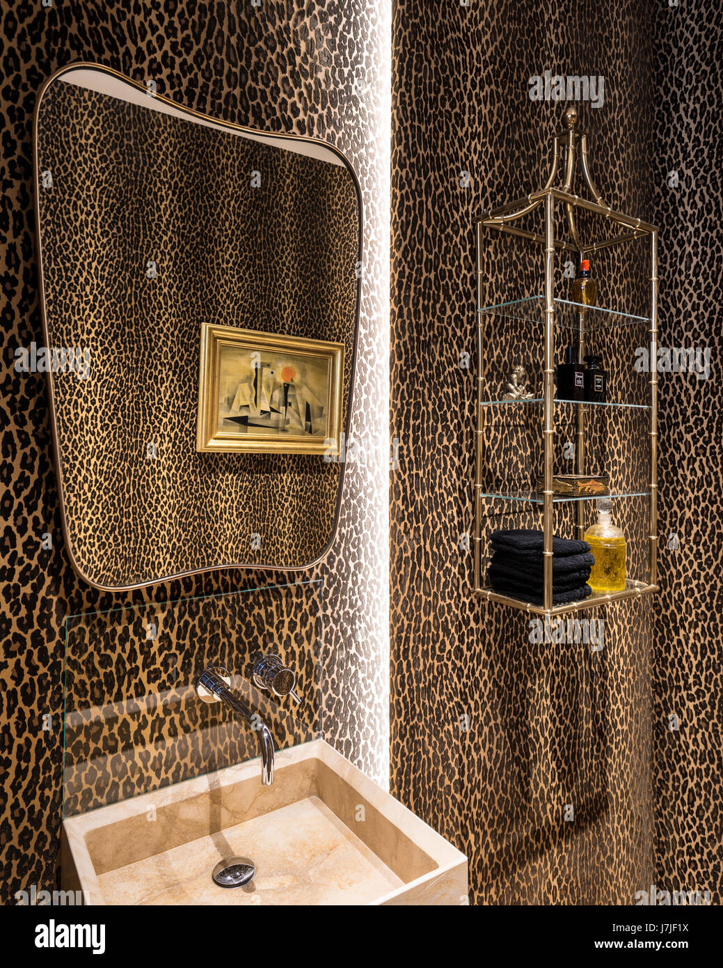 Leopard print Aragon in Ocelot wallpaper by Ralph Lauren in bathroom with  gilt framed retro mirror Stock Photo - Alamy