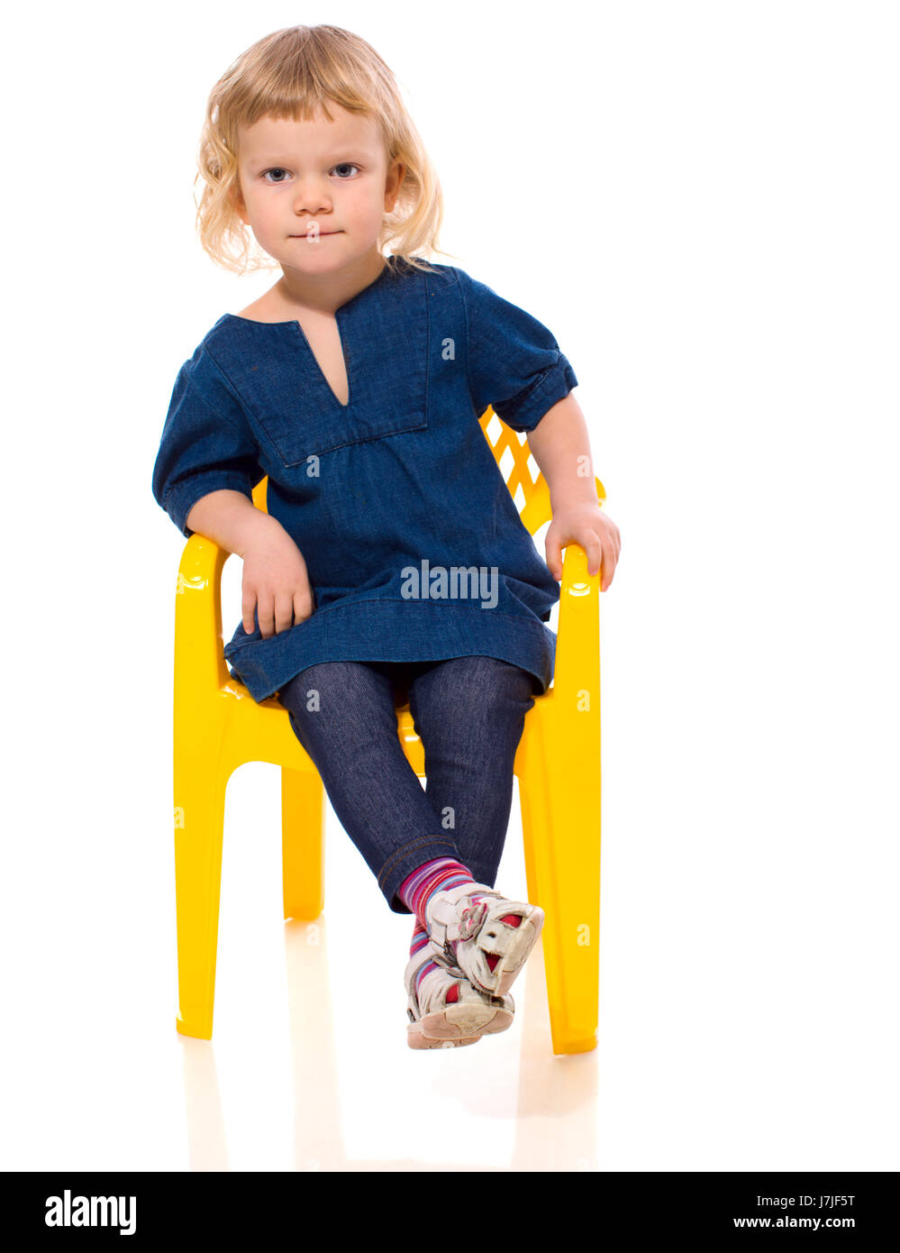 Little girl sitting on chair isolated on white Stock Photo - Alamy