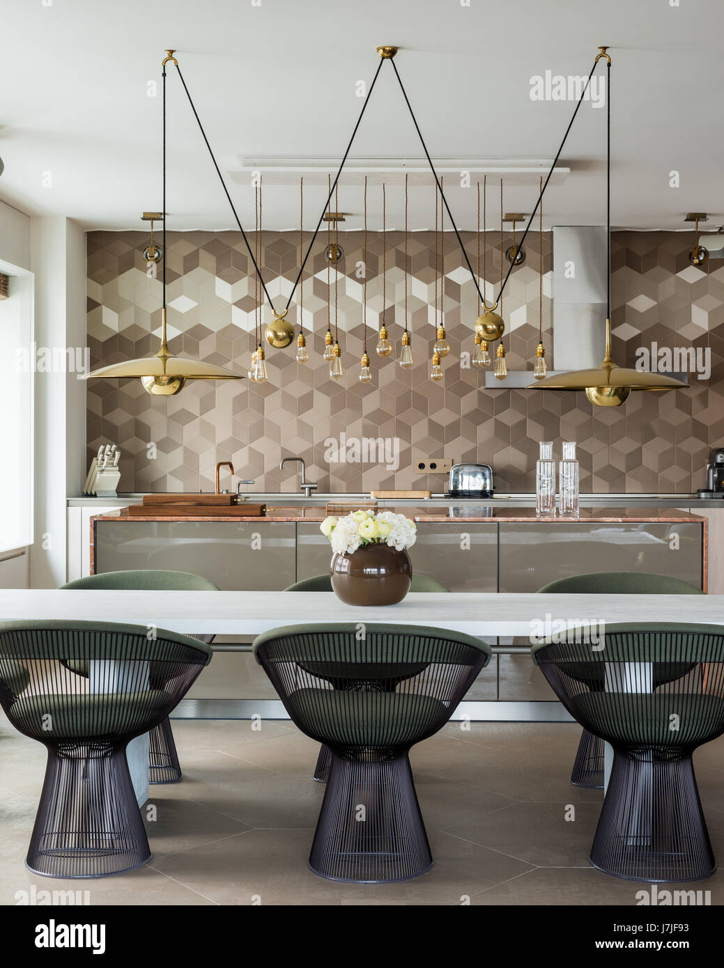 Marble worktop kitchen island with Bulthaup units and brass hanging