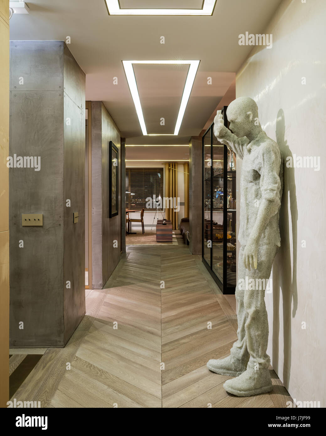 Figure in compressed glass shielding eyes by Daniel Arsham Stock Photo