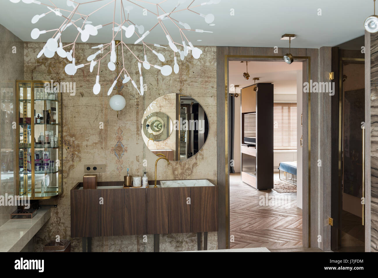 Circular mirror above washbasin with elaborate sculpture Stock Photo