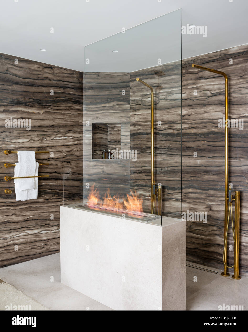 Sienna brown marble lines walls of shower area with gas fire Stock Photo