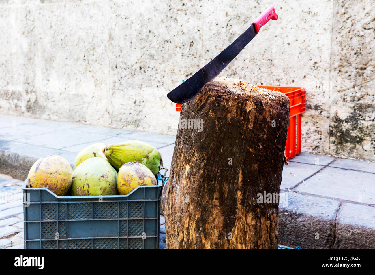 Machete used to chop coconuts for drinks, machete knife, machete, weapon, knife, machete in block of wood Stock Photo
