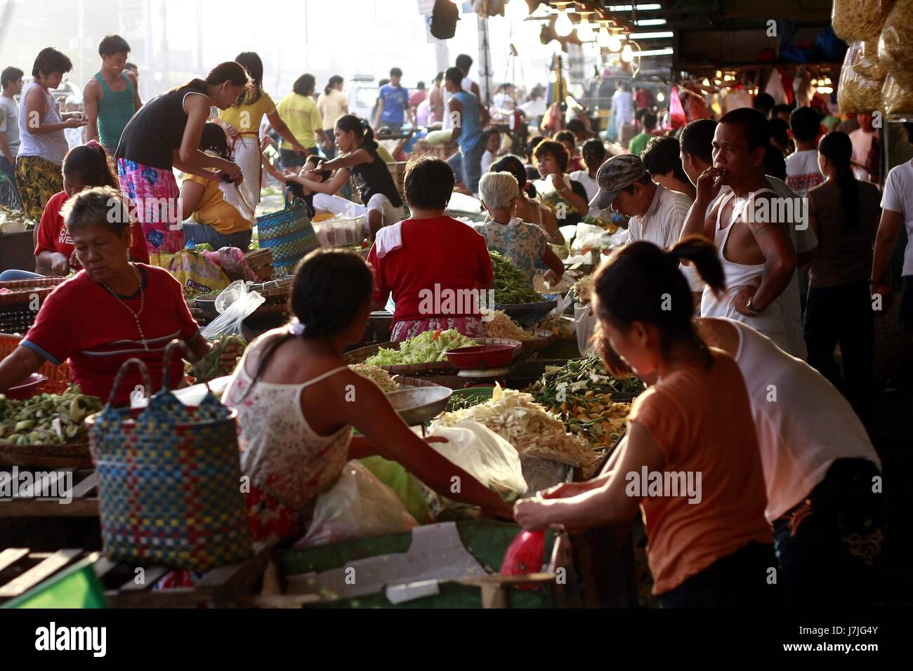 QUEZON CITY, PHILIPPINES JULY 1, 2008 Fruits and vegetable vendors at a popular public market