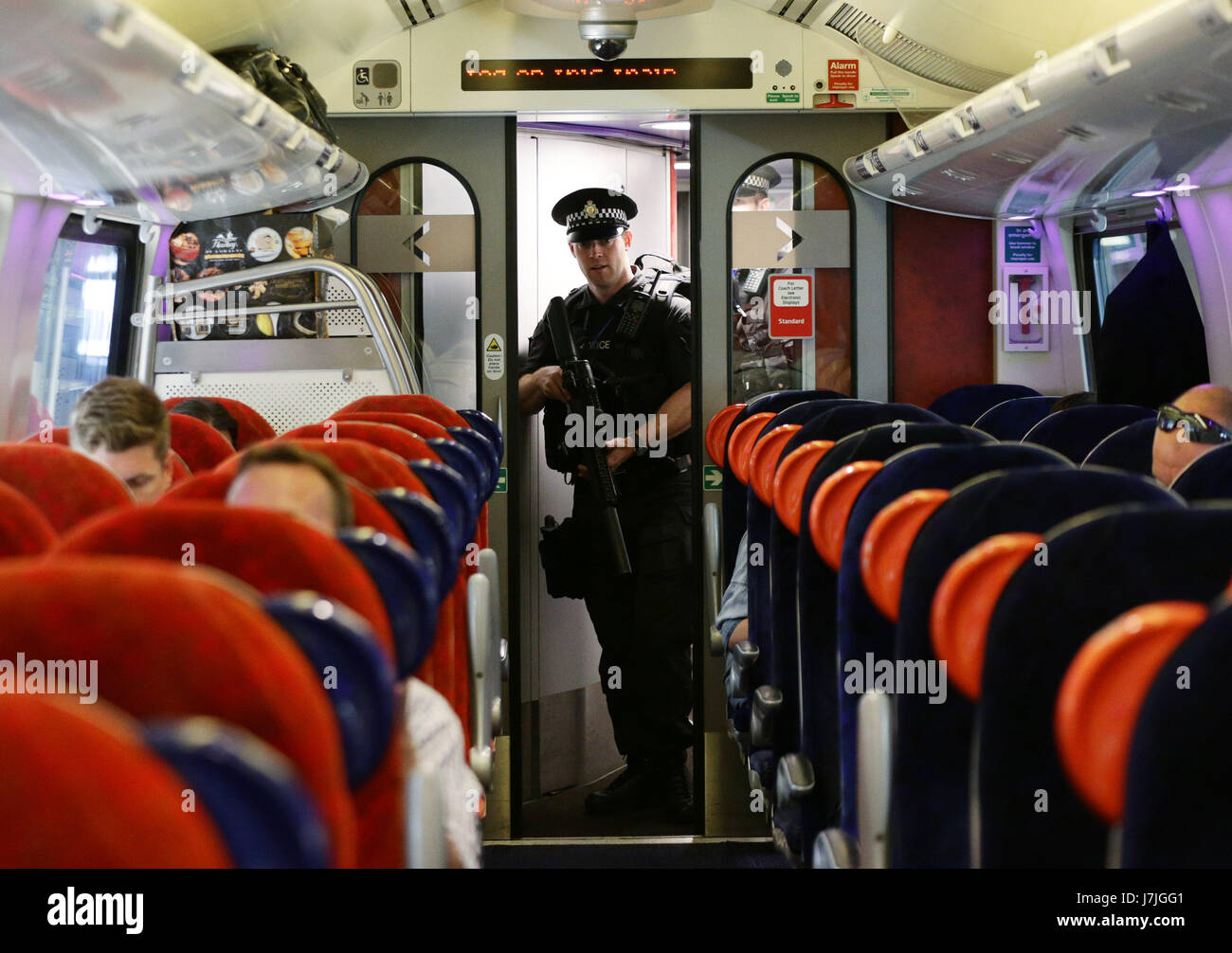 Armed British Transport Police Specialist Operations officers on board a Virgin train to Birmingham New Street at Euston station in London as armed police officers are patrolling on board trains nationwide for the first time. Stock Photo