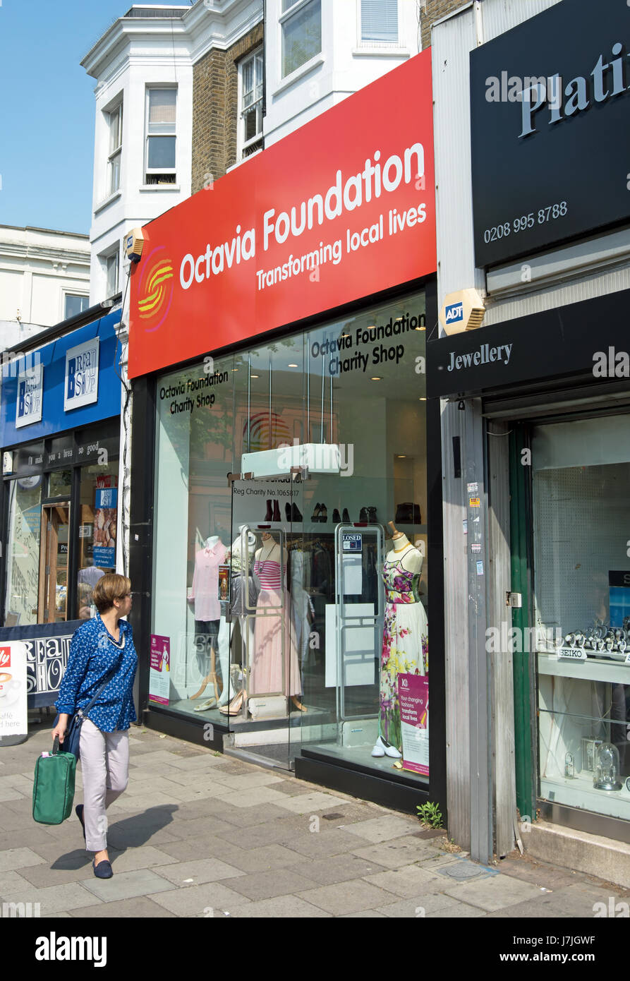 exterior of a octavia foundation charity shop, chiswick, london, england, with passing woman looking in Stock Photo