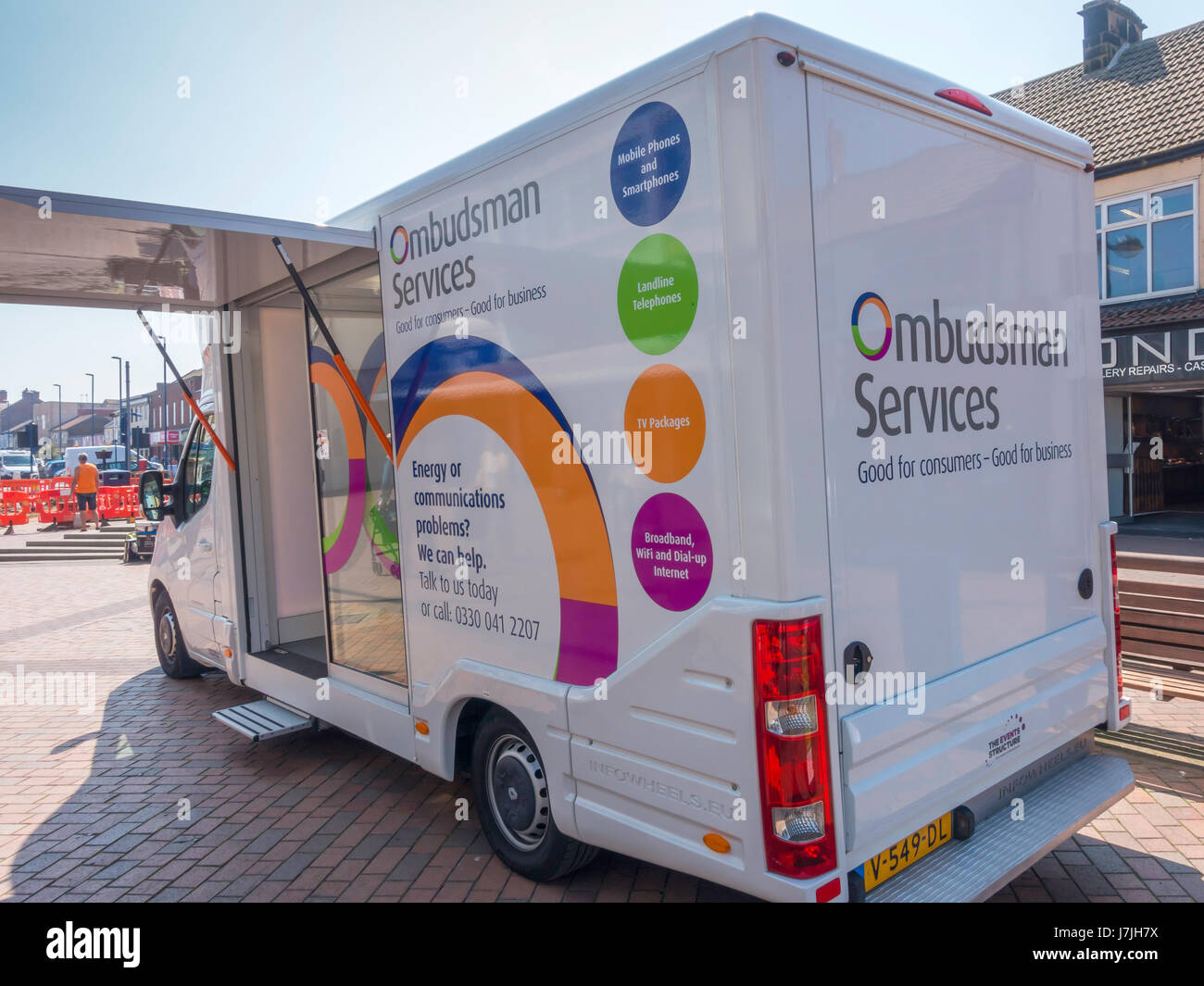 A van offering Ombudsman services for consumers having problems with communication services or energy supplies in a small town High Street Stock Photo