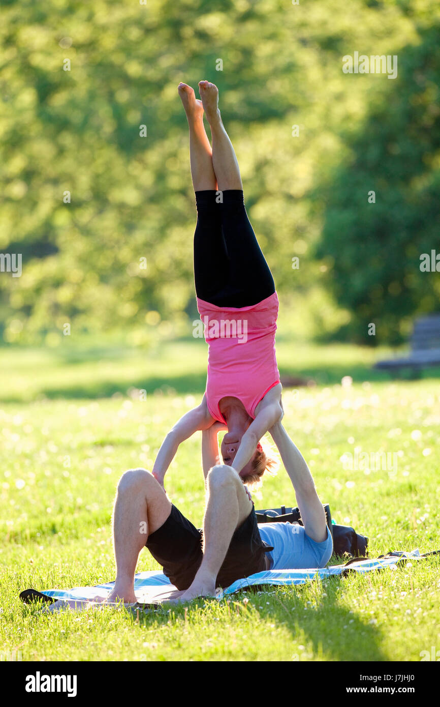 Young Couple Doing Gymnastic Exercise in the Park Stock Photo - Alamy