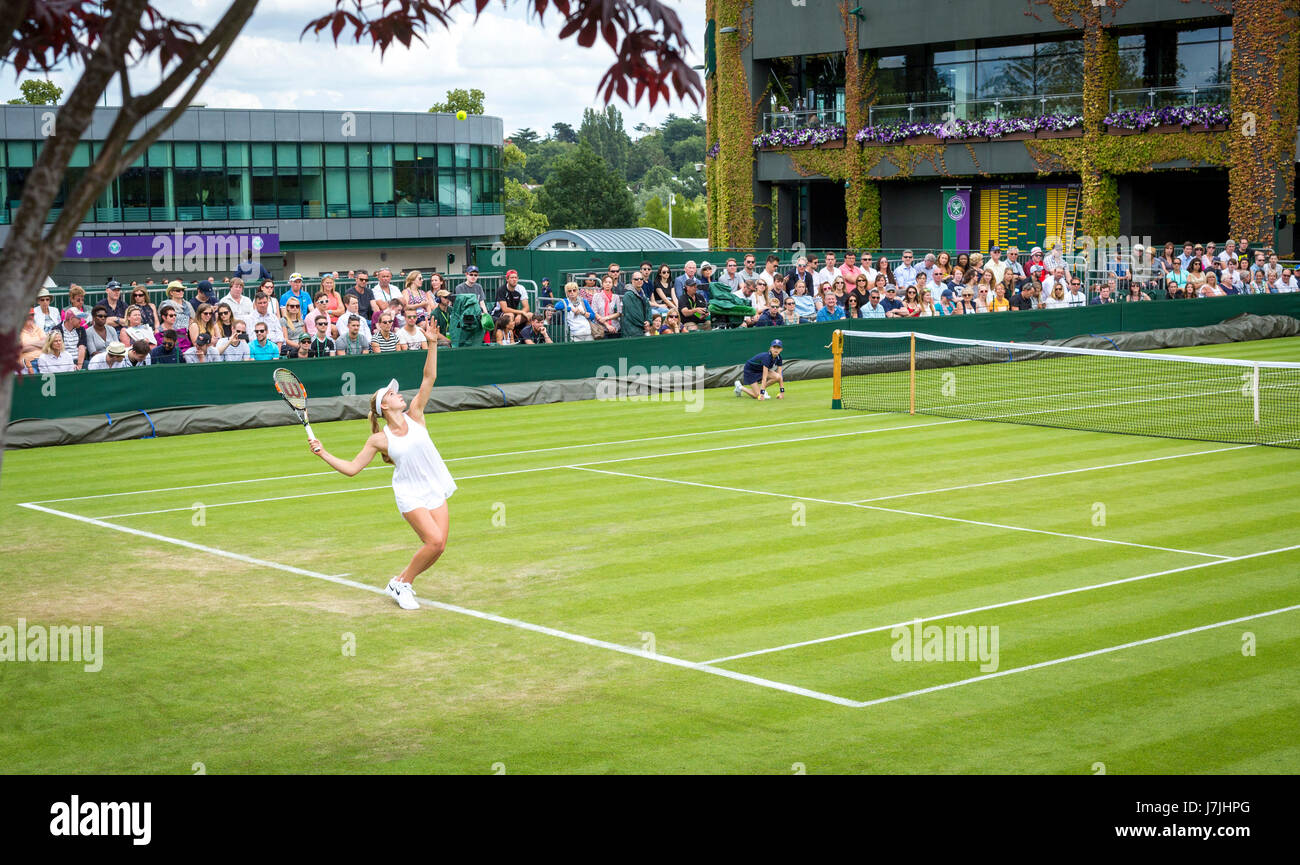 Young British tennis player Katie Swan serving on court 16 at the Wimbledon All England Tennis Championships, 2016 Stock Photo