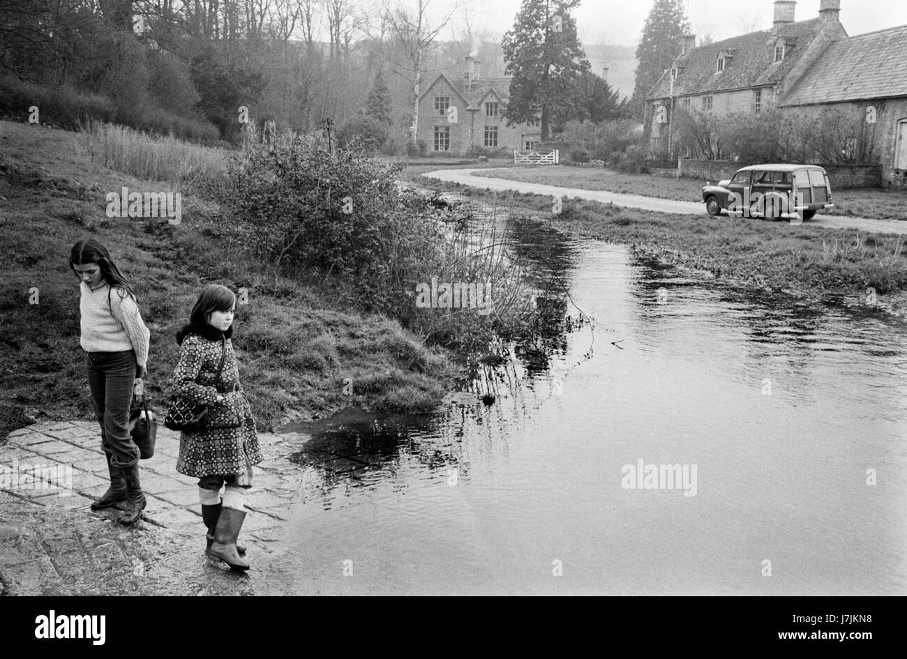 1970s Britain UK. River Eye running through village. Country life Village life style The Cotswolds, Lower Slaughter, Gloucestershire  1975 Lower and Upper Slaughter are twin villages on the River Eye and are know as The Slaughters. HOMER SYKES HOMER SYKES Stock Photo