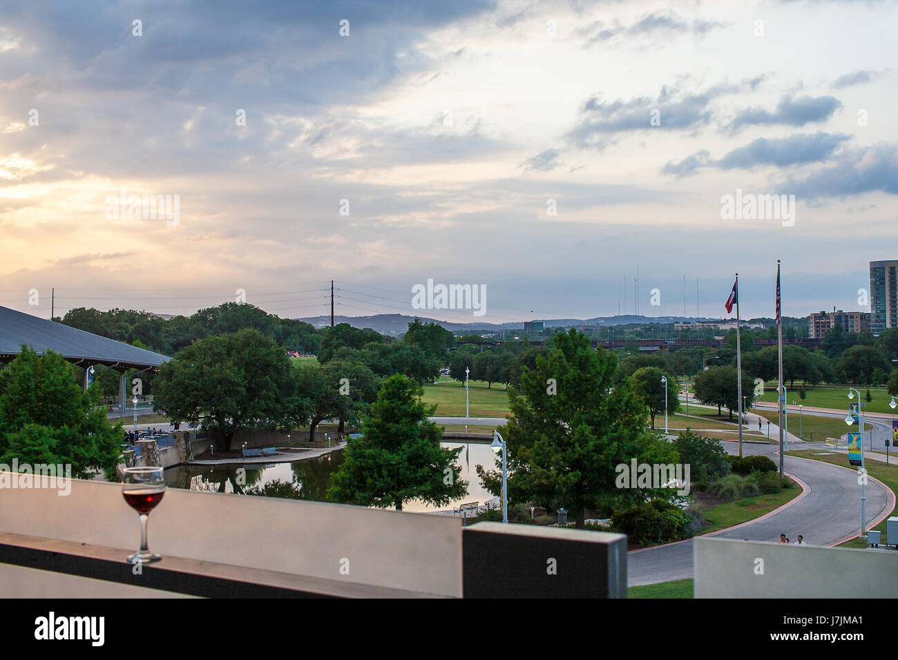 A glass of wine sits on the balcony overlooking the Palmer Event Center in Austin Texas Stock Photo