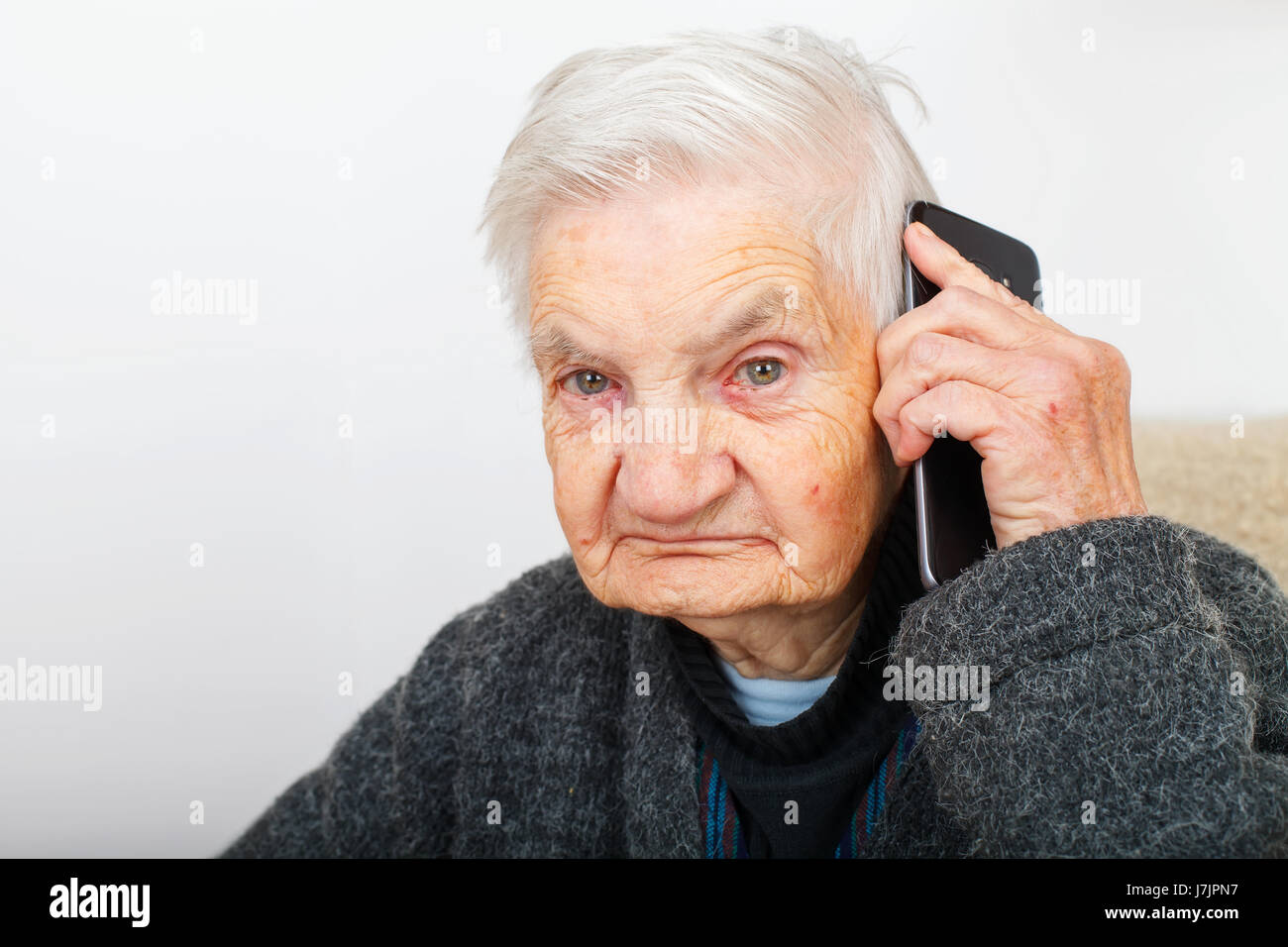 Photo of a senior woman talking on a smartphone Stock Photo - Alamy