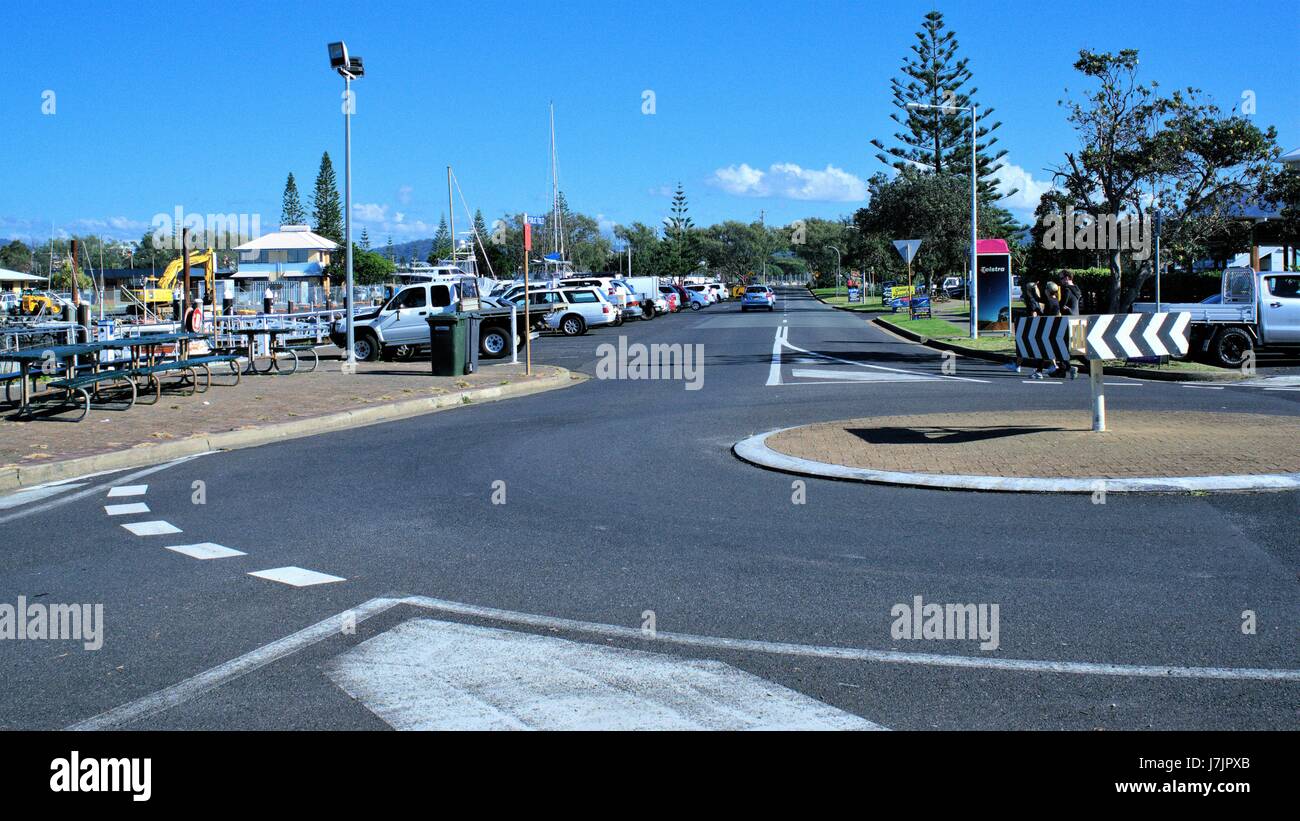 Coffs Harbour Street view, traffic roundabout on 17 May 2017. New South Wales, Australia , unidentifiable people, parked cars, sign boards, bill board Stock Photo