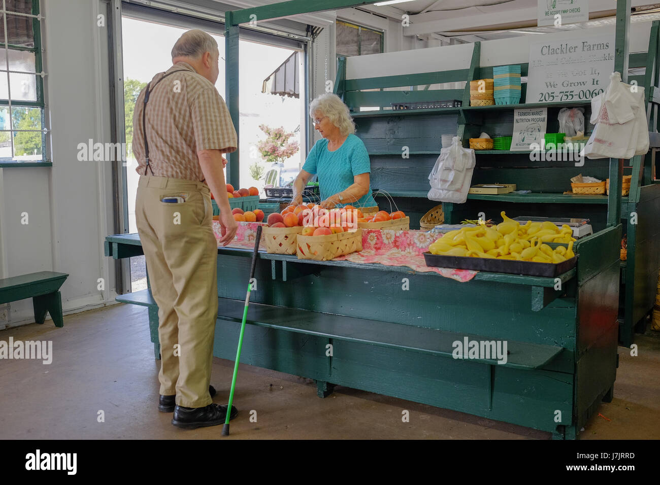 An elderly man shopping at the Curb Market, Montgomery, Alabama, USA for fresh fruits and vegetables, promoting a healthy lifestyle. Stock Photo