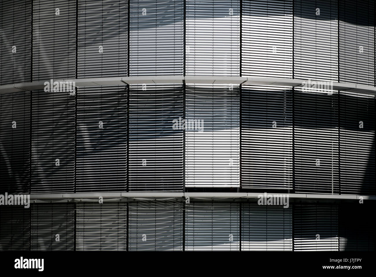 Closed blinds, metallic shutters / jalousie on modern building Stock Photo