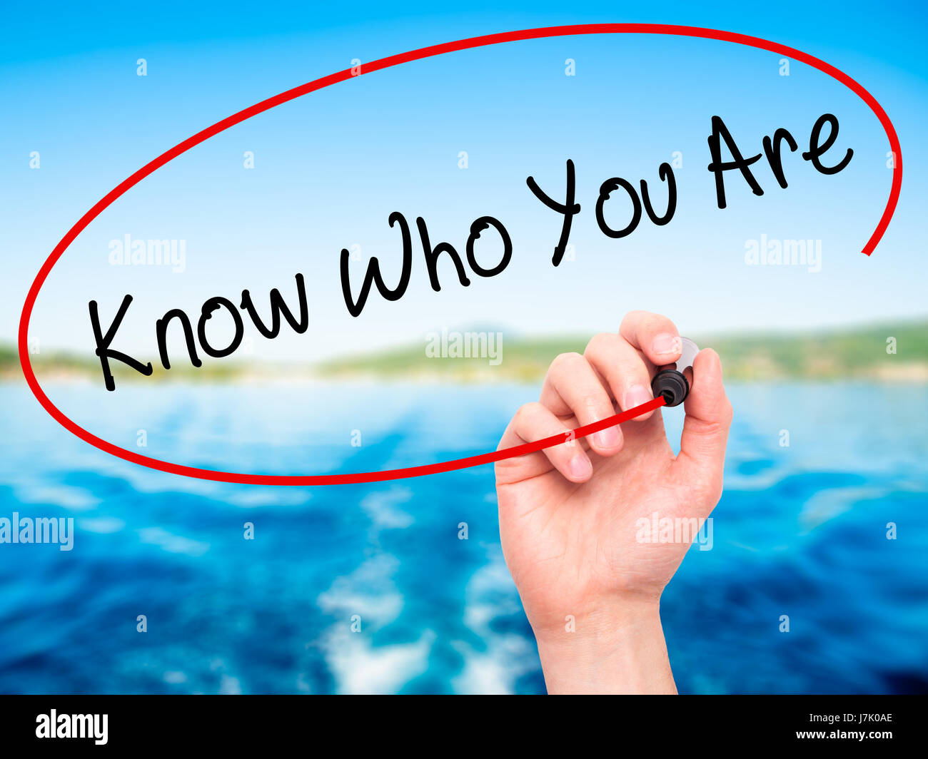 Man Hand writing Know Who You Are with black marker on visual screen. Isolated on nature. Business, technology, internet concept. Stock Photo