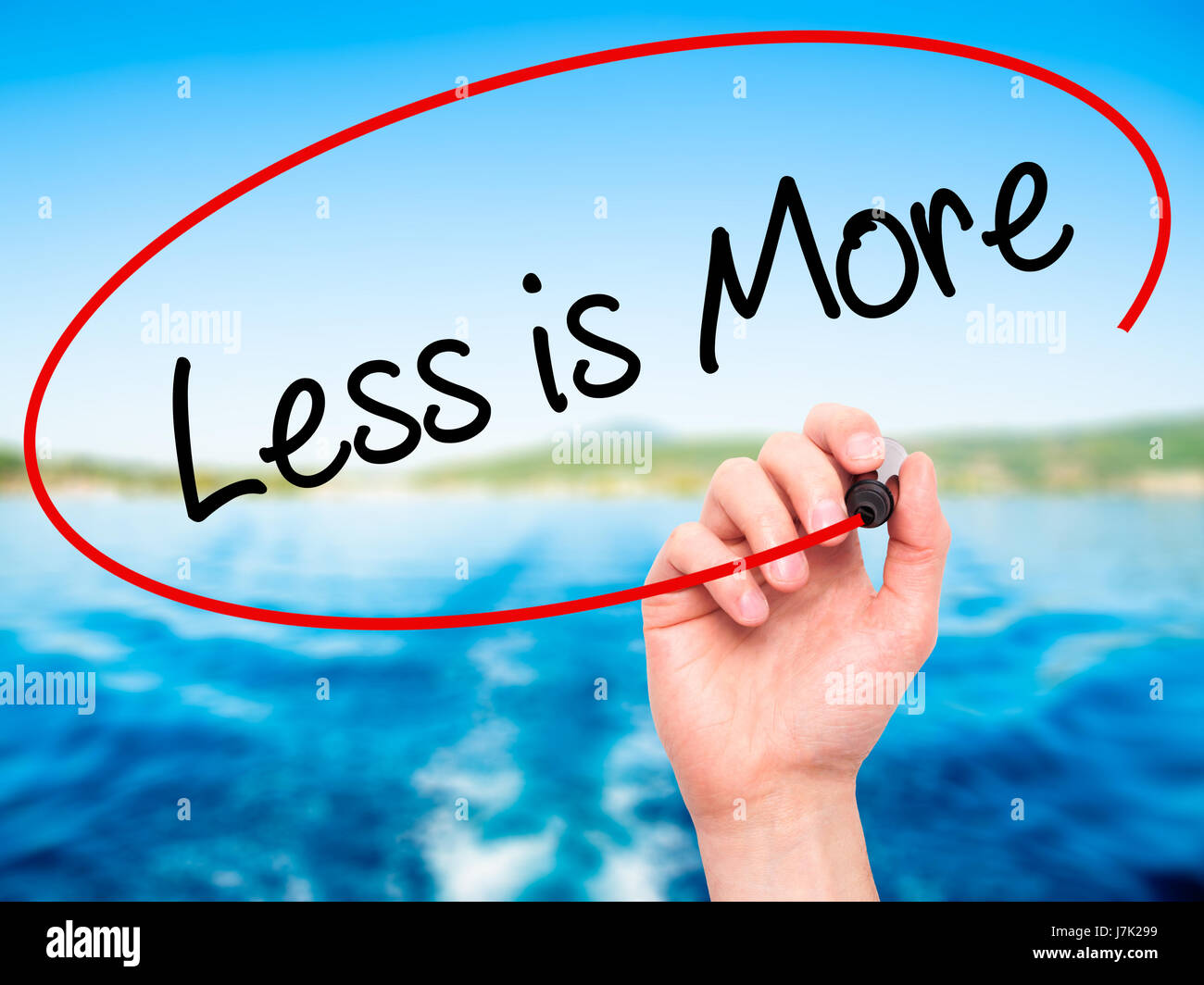 Less Is More Writing Visual Man Hand writing Less is More with black marker on visual screen ...