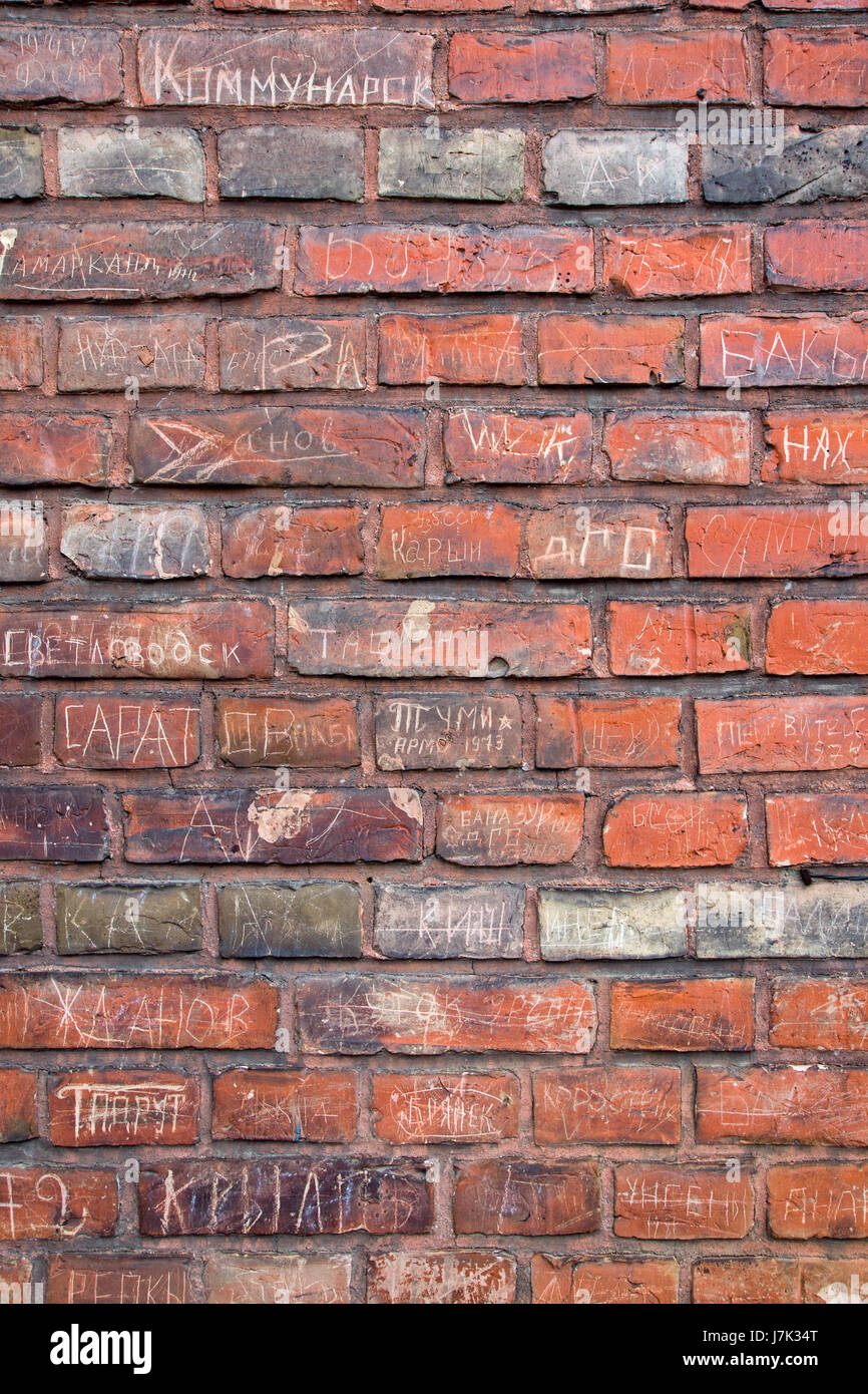 brick wall with inscriptions Stock Photo - Alamy