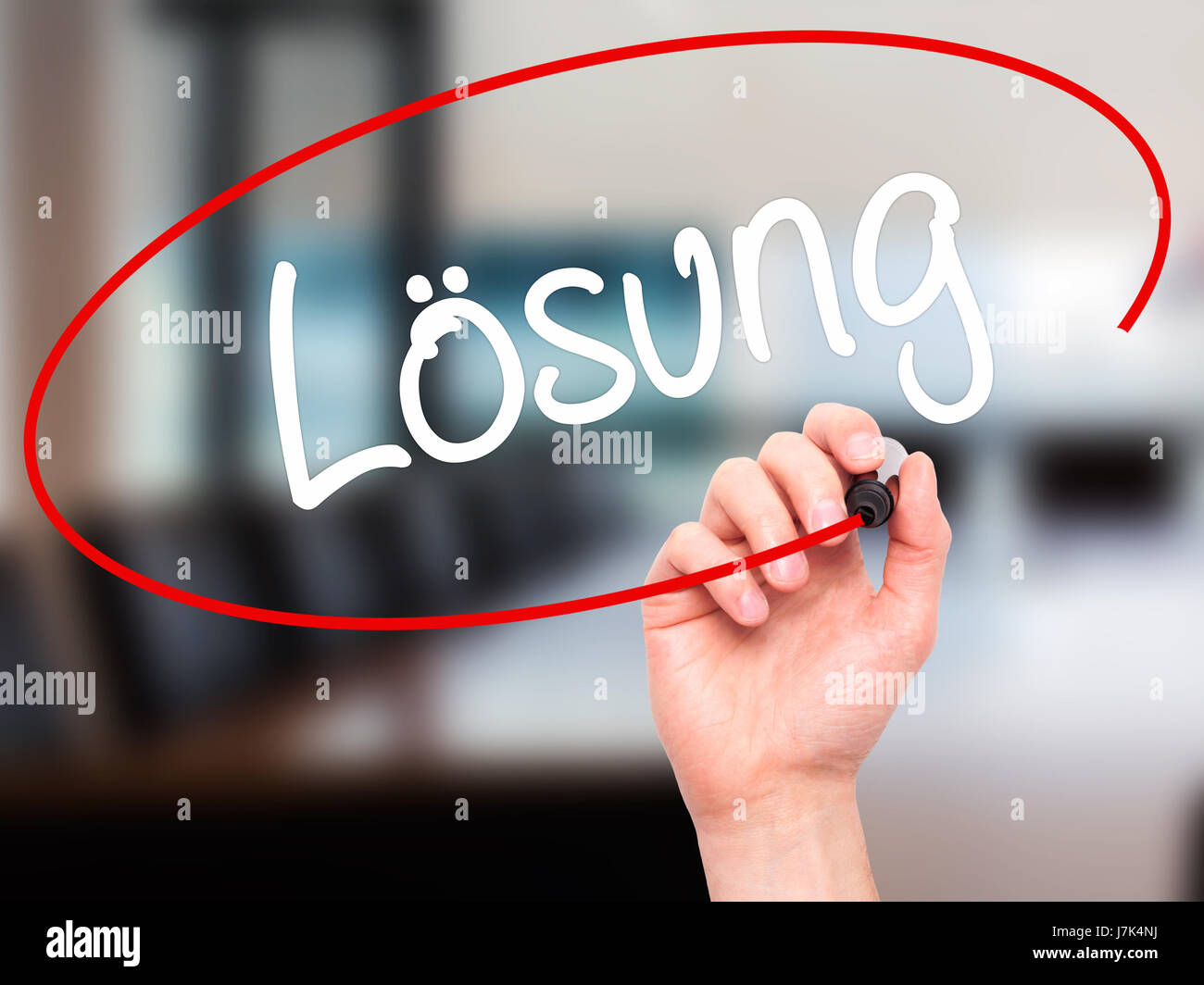Man Hand writing Losung (Solution in German) with black marker on visual screen. Isolated on background. Business, technology, internet concept. Stock Stock Photo