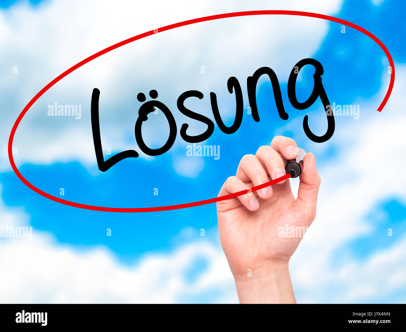 Man Hand writing Losung (Solution in German) with black marker on ...